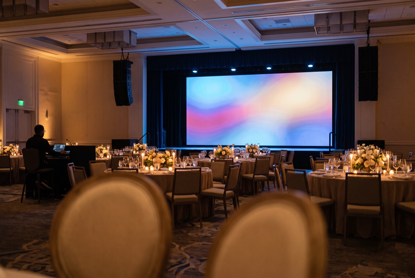 Corporate event production setup in a Miami ballroom with stage, lighting, and audio in place
