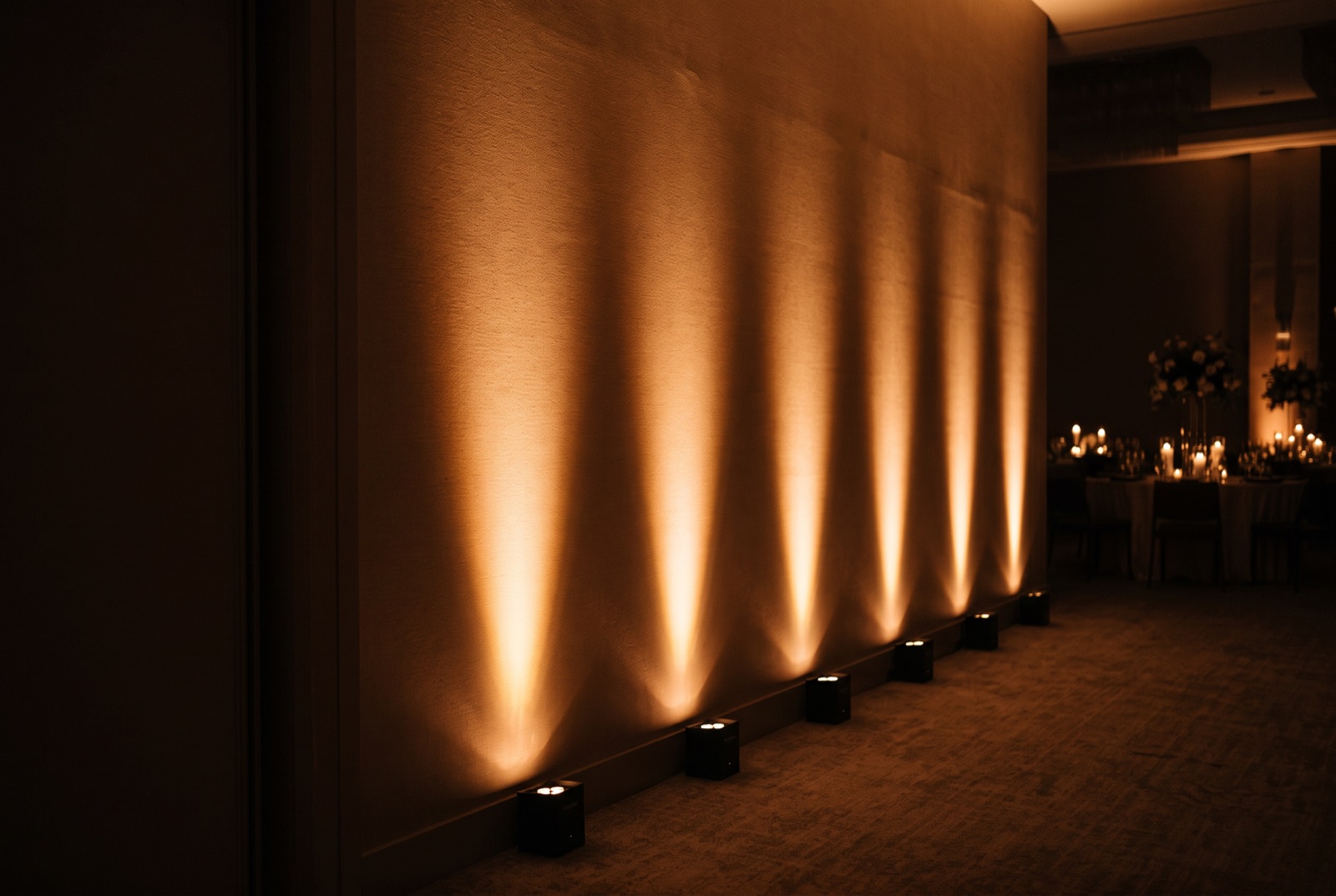LED uplighting washing color up the walls of a Miami wedding ballroom