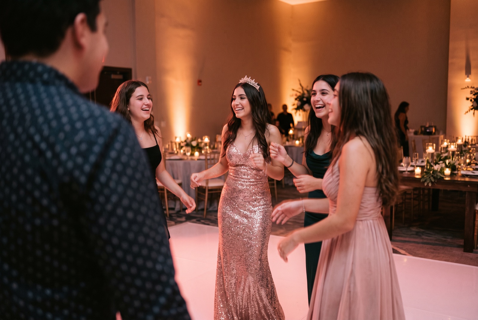 Sweet 16 guest dancing with her friends on a packed floor at a Miami party