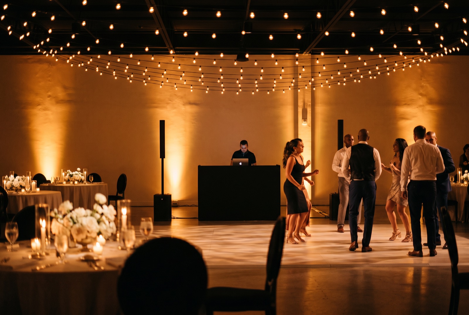 Full wedding DJ package with sound, lighting, and booth set up at a Miami reception